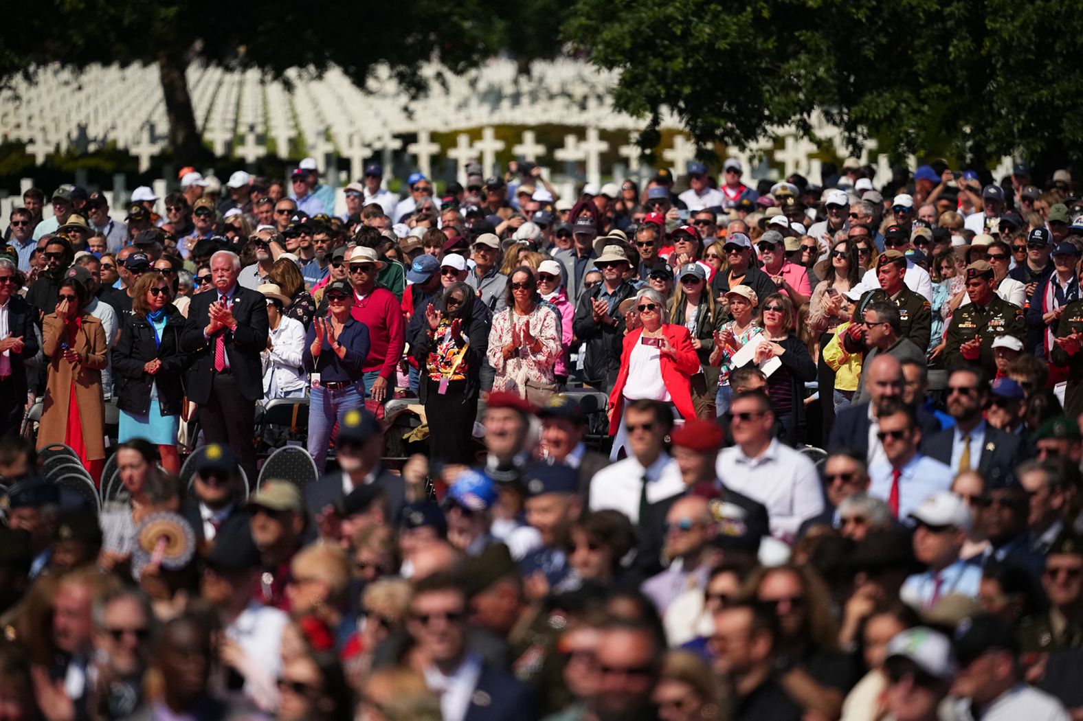 People wait for the start of the ceremony at the Normandy American Cemetery and Memorial.