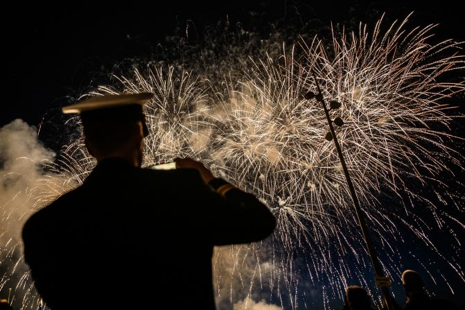 A UK soldier watches fireworks in Arromanches-les-Bains, France, on Thursday, June 6.