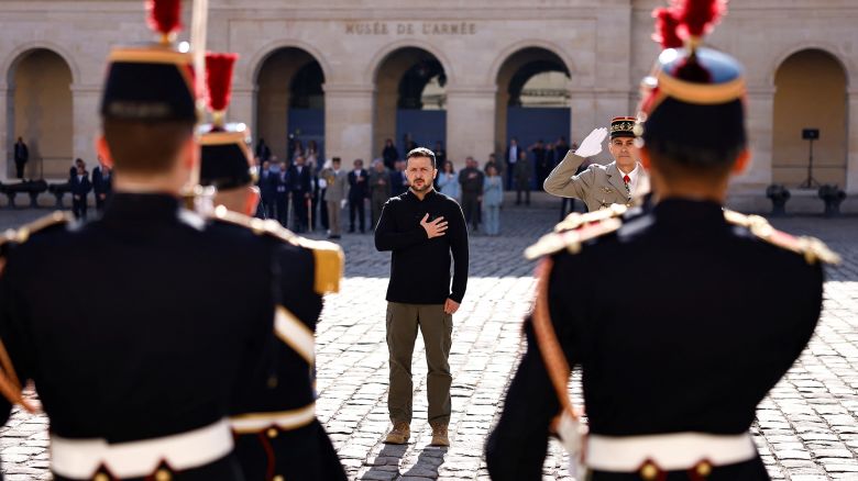 Ukraine's President Volodymyr Zelensky (C) listens to Ukrainian national anthem during a military honour ceremony at the Invalides in Paris on June 7, 2024. (Photo by Sameer Al-Doumy / POOL / AFP) (Photo by SAMEER AL-DOUMY/POOL/AFP via Getty Images)