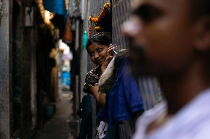 A woman peeps out along a narrow alley of the Dharavi slum area of Mumbai, India, on April 14.