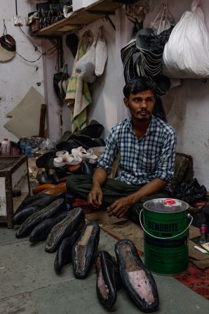 A man works at Masoom Ali Shaikh's workshop in the Dharavi slum area of Mumbai, India, on April 14.