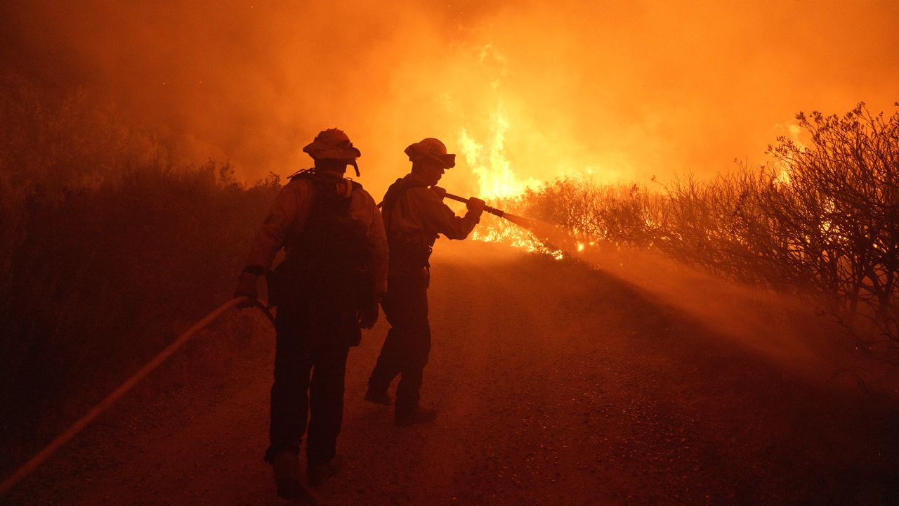 Firefighters work against the advancing Post Fire on Sunday, June 16, 2024, in Gorman, Calif. (AP Photo/Eric Thayer)