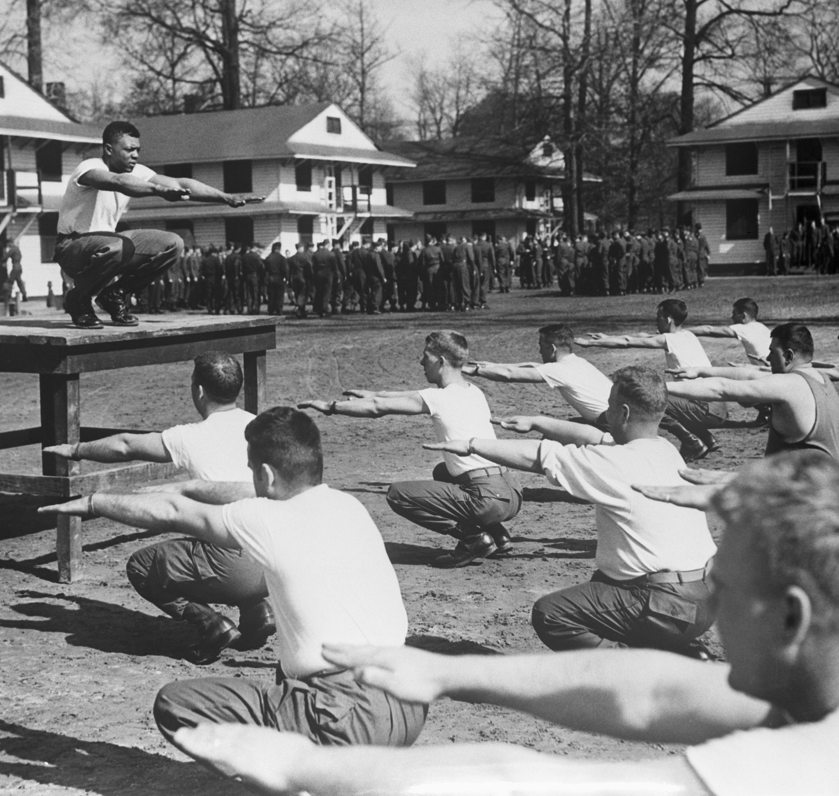 Mays, then a physical training instructor at Fort Eustis, Virginia, leads soldiers through a calisthenics session on February 19, 1953.