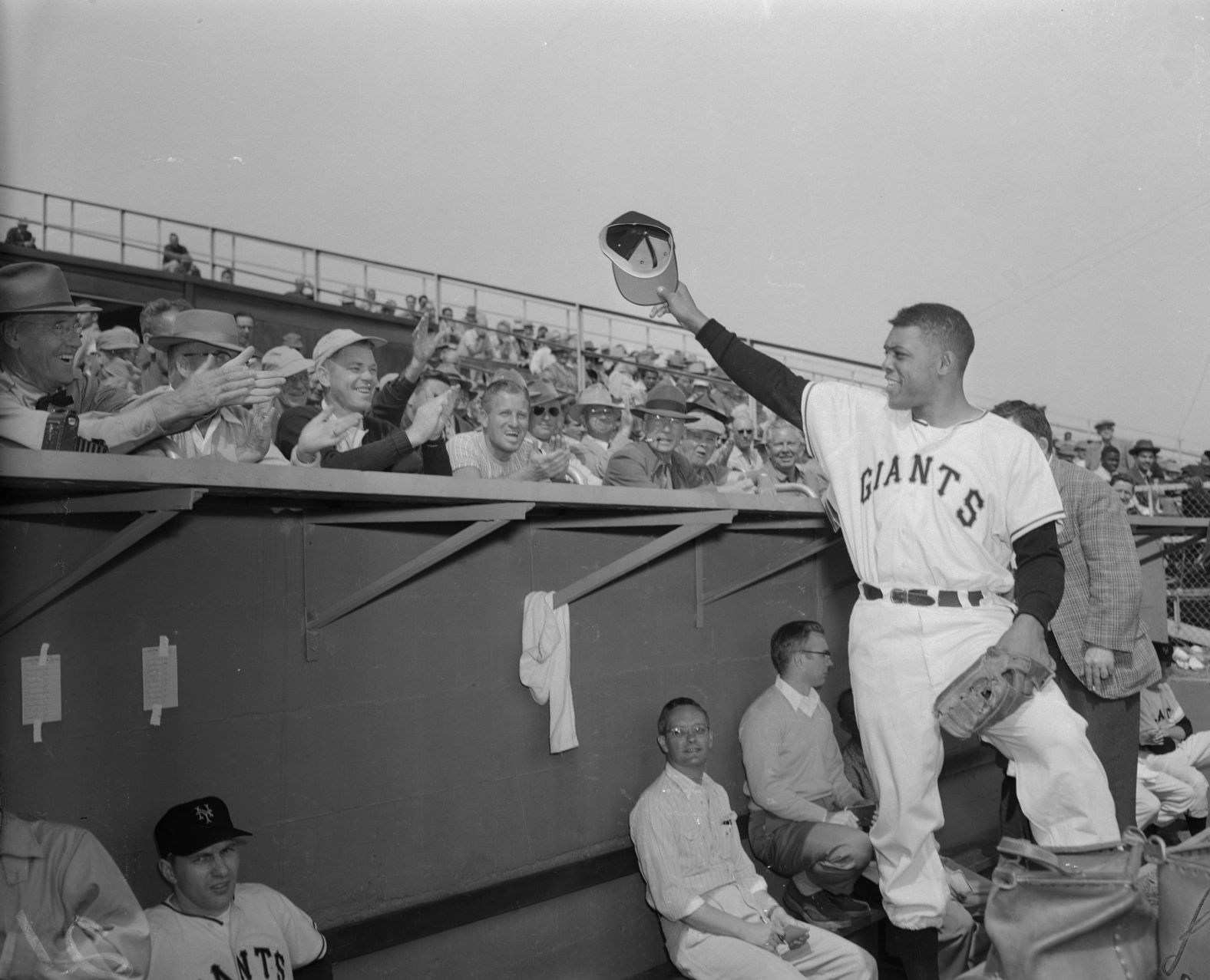 Released from the Army after two years of service, Mays waves to an assembled crowd during a spring training session in Phoenix, Arizona on March 4, 1954.