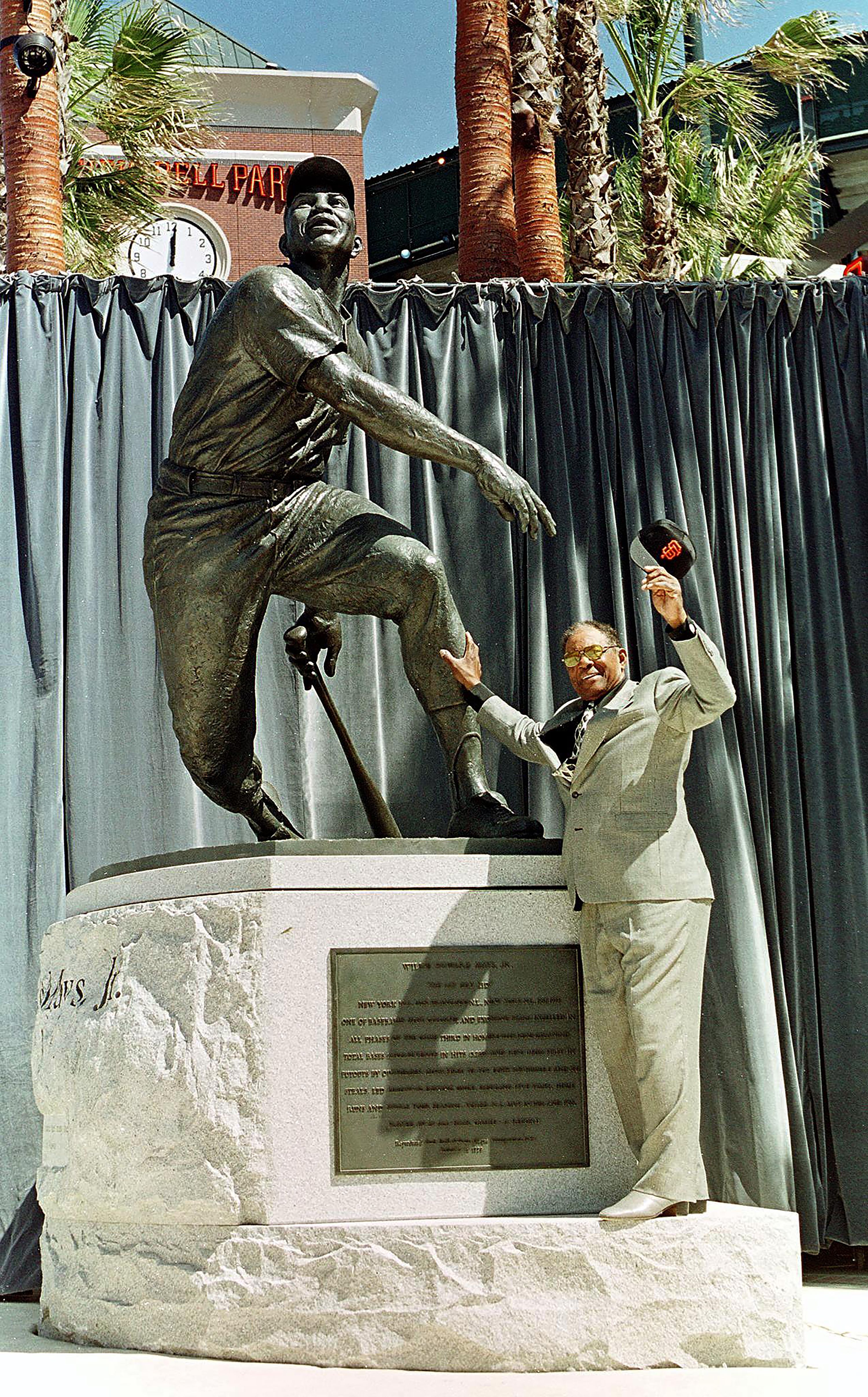 Mays stands next to a statue of himself during its dedication.