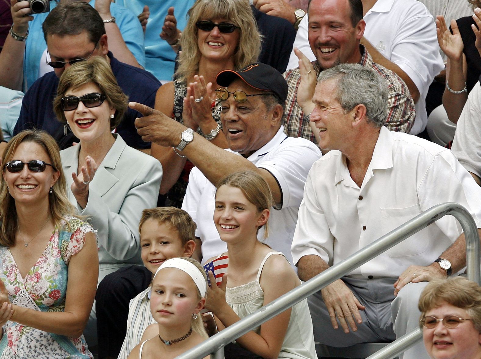 From left: First lady Laura Bush, Mays and President George W. Bush watch "Tee Ball on the South Lawn" at the White House in Washington, DC on July 30, 2006. The game featured teams from Little League's Challenger Division, organized for mentally and physically disabled children. 