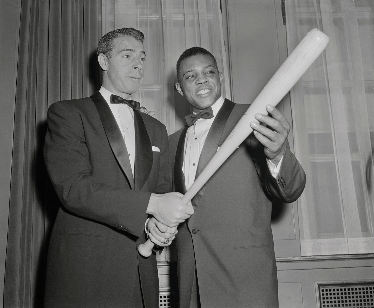 Mays, right, gets batting tips from Joe DiMiaggio, at the 32nd annual dinner of the Baseball Writers at the Waldorf Astoria in 1955. Mays, the reigning National League MVP, won the Scribes' Sid Mercer Award as "Player of The Year." 