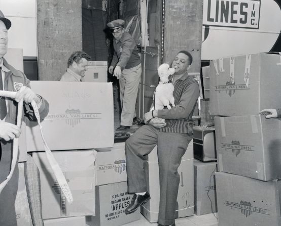 Mays gets a kiss from his dog Pepe while moving into their new San Francisco home on January 15, 1958. 