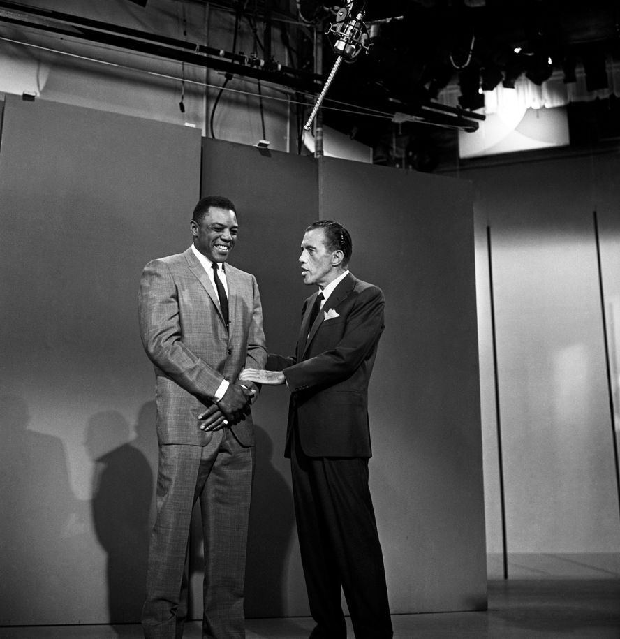 Mays shakes hands with television host Ed Sullivan as the pair talk about the All-Star Game and Mays' batting average on "The Ed Sullivan Show."