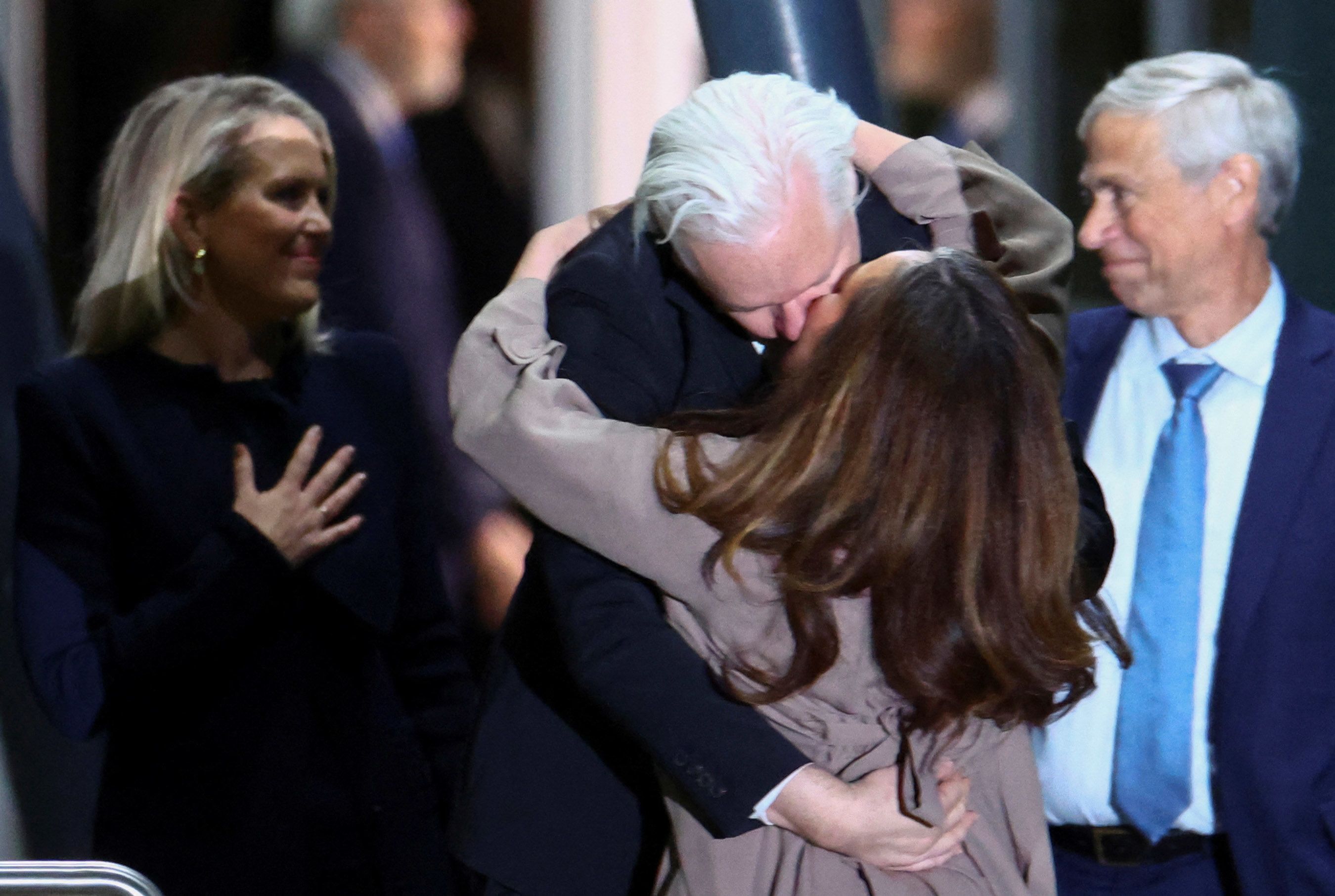 Assange kisses wife upon arrival.