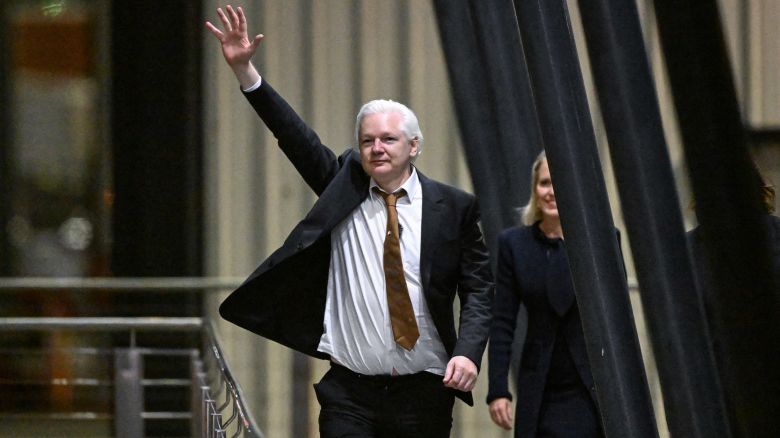 WikiLeaks founder Julian Assange waves after arriving at Canberra Airport in Canberra on June 26, 2024, after he pleaded guilty at a US court in Saipan to a single count of conspiracy to obtain and disseminate US national defence information. WikiLeaks founder Julian Assange returned home to Australia to start life as a free man June 26 after admitting he revealed US defence secrets in a deal that unlocked the door to his London prison cell. (Photo by WILLIAM WEST / AFP) (Photo by WILLIAM WEST/AFP via Getty Images)