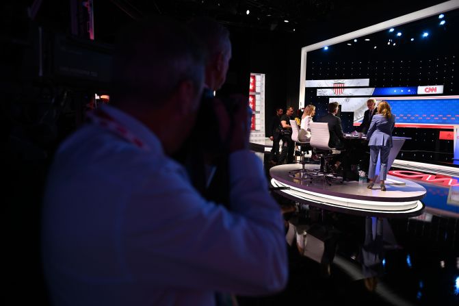 First lady Jill Biden, right, joins her husband as he talks with moderators Jake Tapper and Dana Bash after the debate.