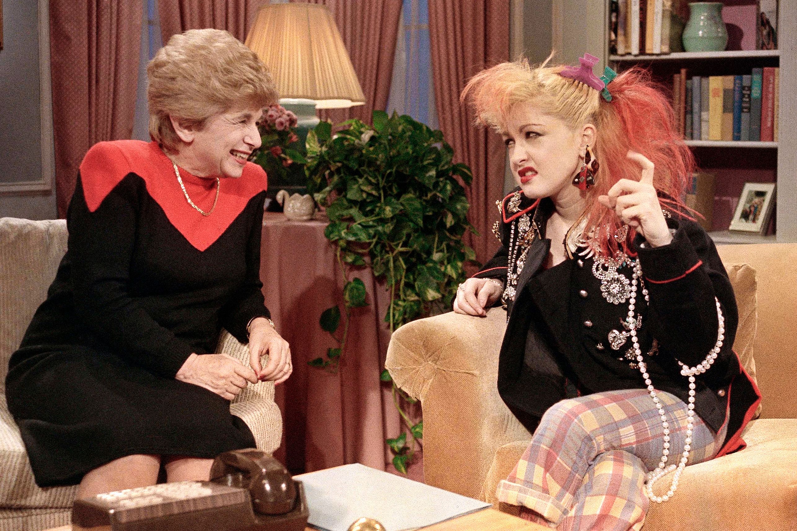 Sex therapist Dr. Ruth Westheimer talks with rock singer Cyndi Lauper in New York, Jan. 17, 1985.