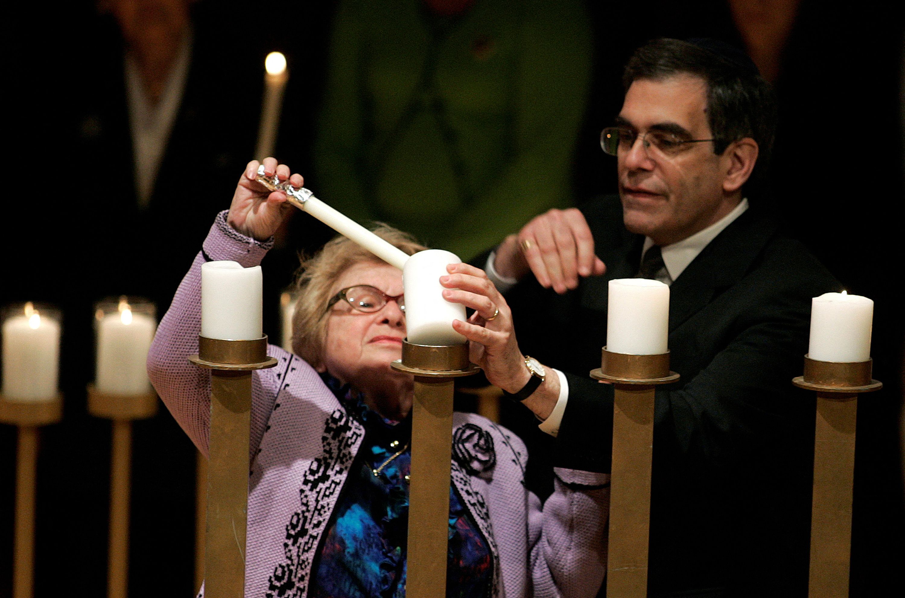 Holocaust survivor Ruth Westheimer lights a candle during the Annual Gathering of Remembrance in New York April 23, 2006.