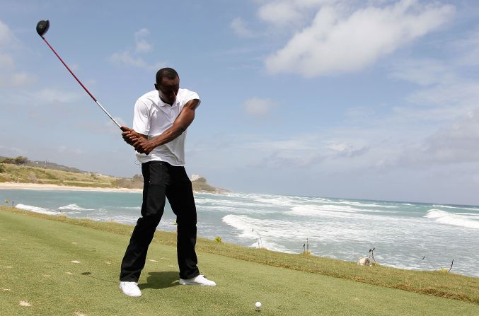 MONTEGO BAY, JAMAICA - APRIL 16:  Usain Bolt tees up a golf ball as he drives it into the Caribbean Sea during the quarterfinal matches of The Mojo 6 Jamaica LPGA Invitational at Cinnamon Hill Golf Course on April 16, 2010 in Montego Bay, Jamaica.  (Photo by Kevin C. Cox/Getty Images)