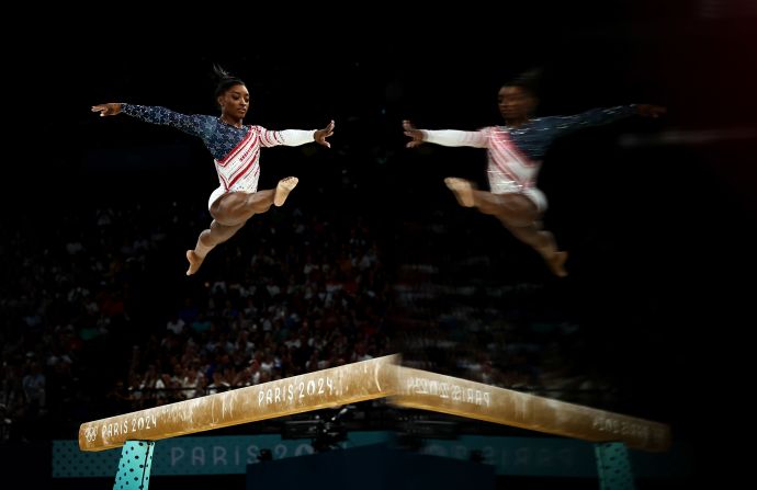 Biles competes on the balance beam during the team competition at the Paris Olympics in July 2024. <a href=