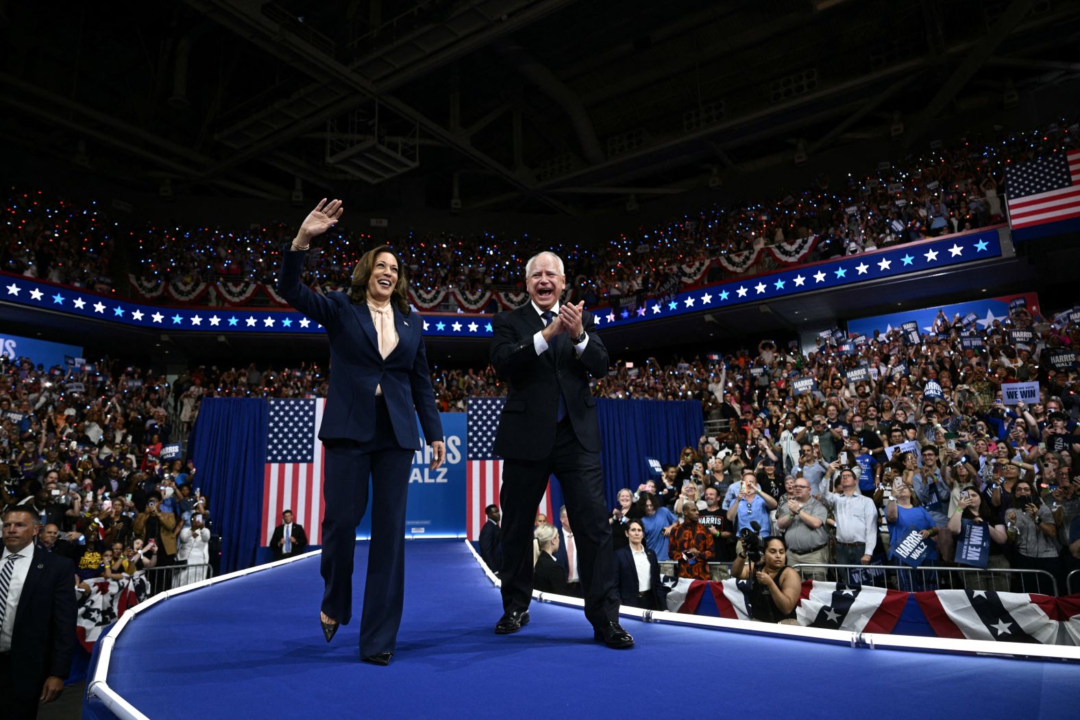 Harris and her running mate, Minnesota Gov. Tim Walz, hold <a href=