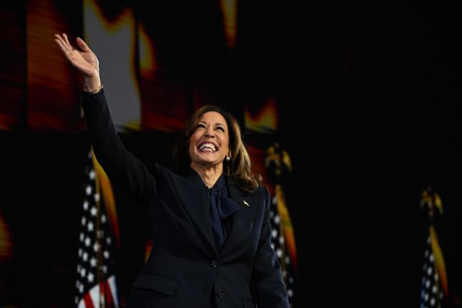 Harris waves as she takes the stage for her speech at the <a href="index.php?page=&url=https%3A%2F%2Fwww.cnn.com%2F2024%2F08%2F19%2Fpolitics%2Fgallery%2Fdemocratic-national-convention%2Findex.html" target="_blank">Democratic National Convention</a> in August 2024. She officially became the first Black woman and first Asian American to lead a major-party ticket.