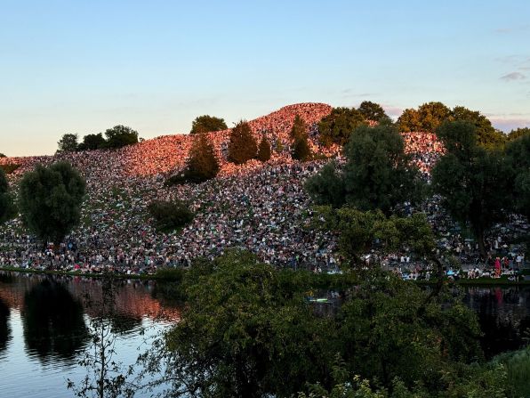 Thousands of fans gather on a hill outside a Swift concert in Munich, Germany, in July 2024.