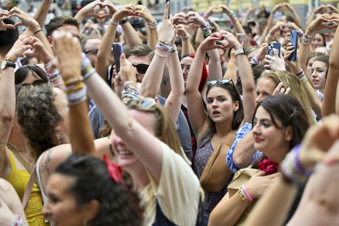 Swifties hold up hand hearts as they gather in the streets of Vienna, Austria, in August 2024. Organizers canceled Swift's three concerts there after <a  target="_blank">authorities said they foiled a terror attack</a>.