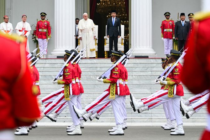 Indonesia's President Joko Widodo and Pope Francis watch as the honor guards march past during a ceremonial welcome at the Presidential Palace in Jakarta, Indonesia, on September 4, 2024.