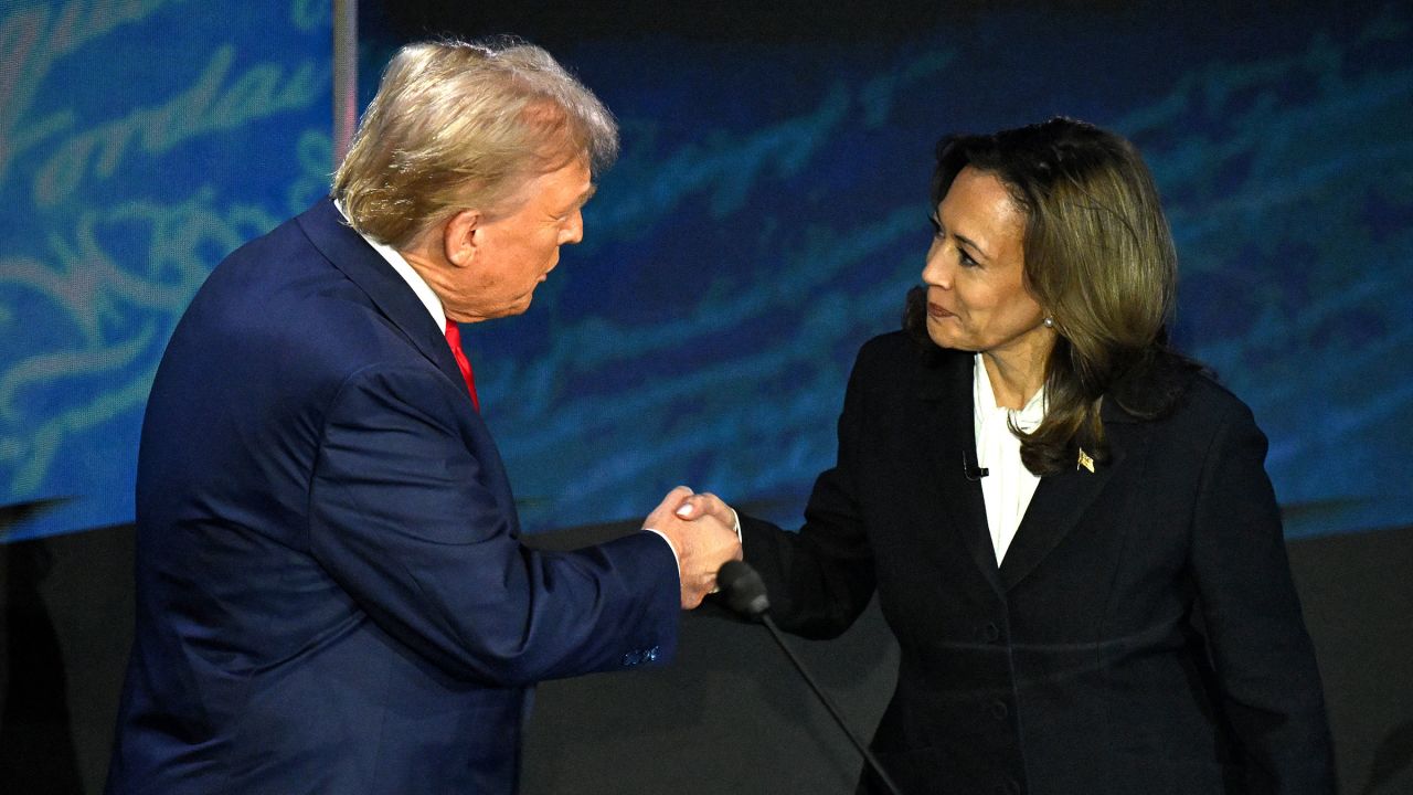 Vice President Kamala Harris (R) shakes hands with former President Donald Trump during a presidential debate at the National Constitution Center in Philadelphia, Pennsylvania, on September 10, 2024.