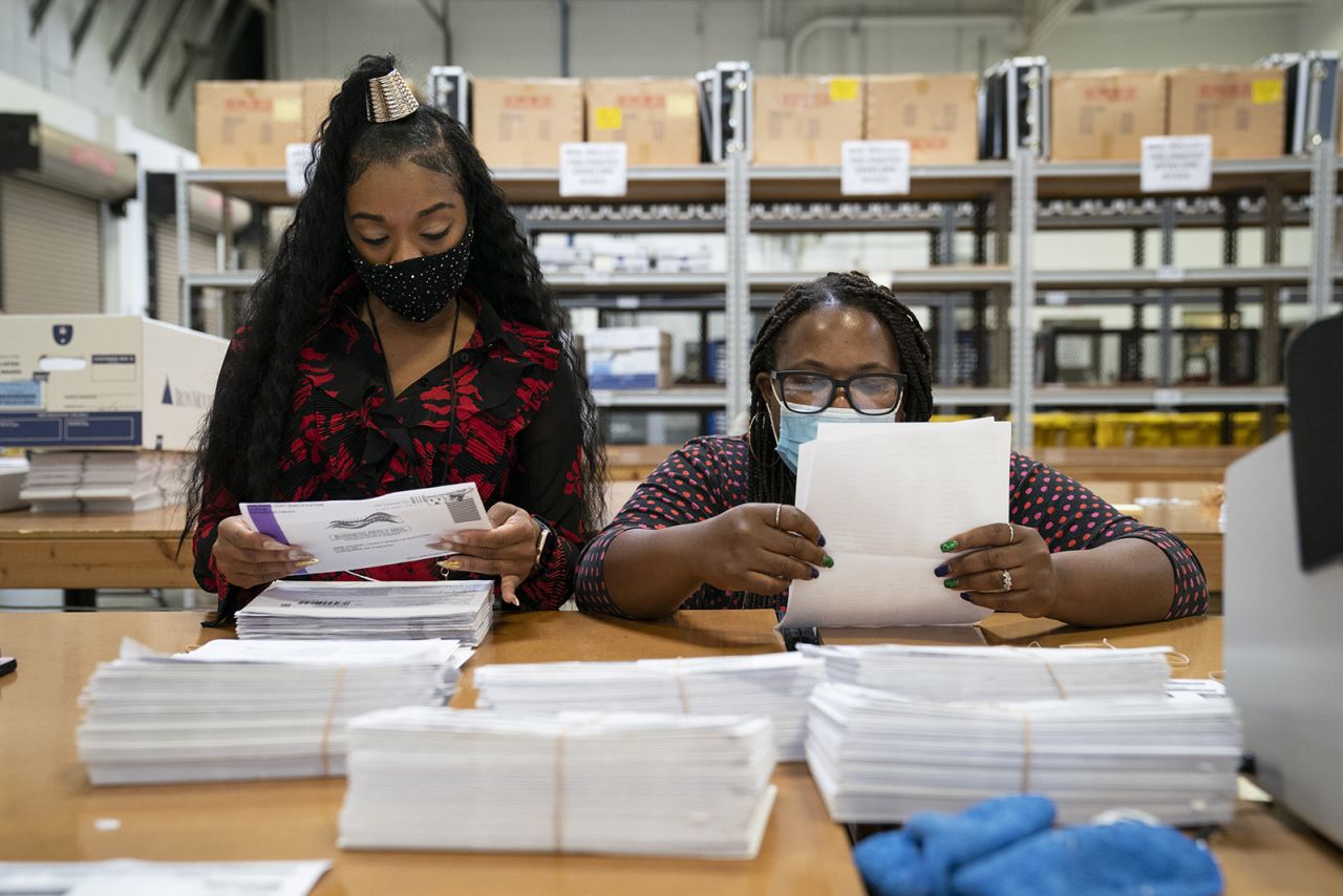 Working in bipartisan pairs, canvassers process mail-in ballots in a warehouse at the Anne Arundel County Board of Elections headquarters on October 7, in Glen Burnie, Maryland.