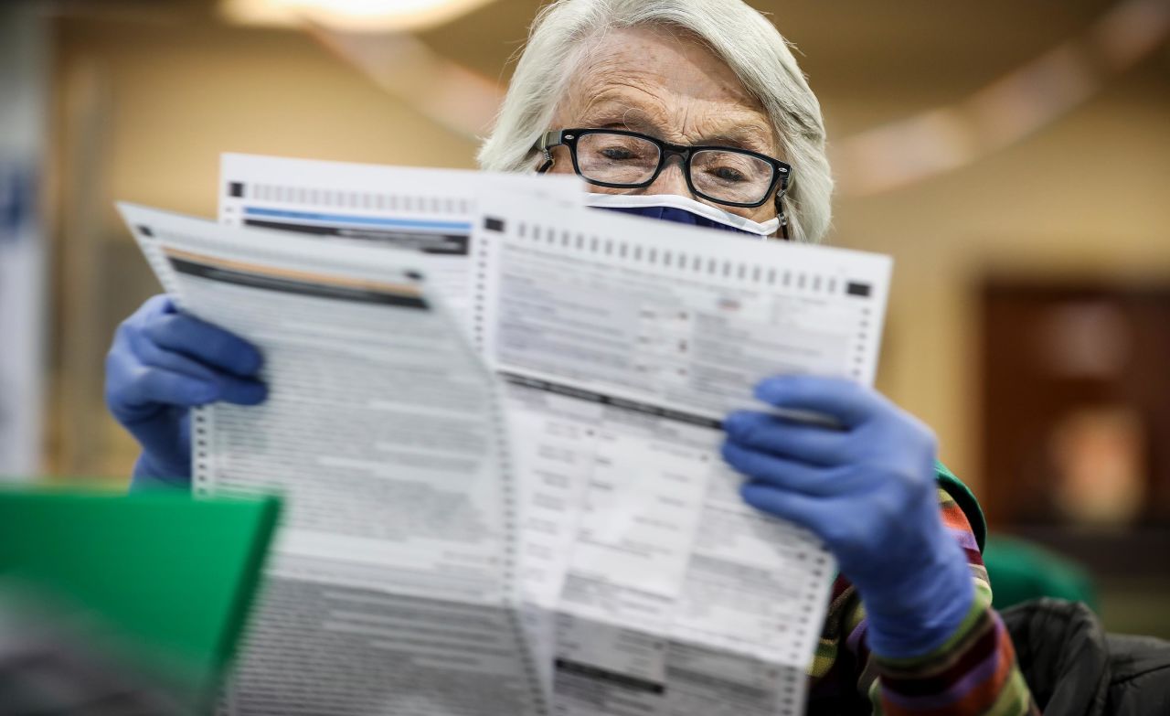 Election judge Bonnie Carr of Denver, Colorado pours over a ballot as she prepares them to be counted at the Denver Elections Division Building on November 3, in Denver, Colorado.