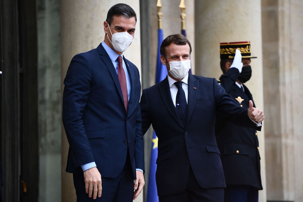 French President Emmanuel Macron (R) welcomes Spanish Prime minister Pedro Sanchez prior to a meeting marking the 60th anniversary of the creation of the Organisation for Economic Co-operation and Development (OECD) at the Elysee palace in Paris, on December 14, 2020. 