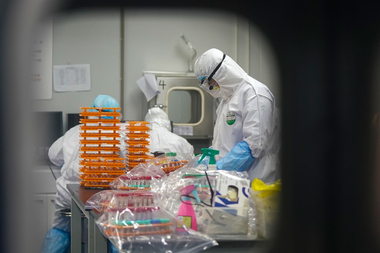 Medical workers in protective suits work at a coronavirus detection lab in Wuhan in central China's Hubei Province on Saturday, February 22. 