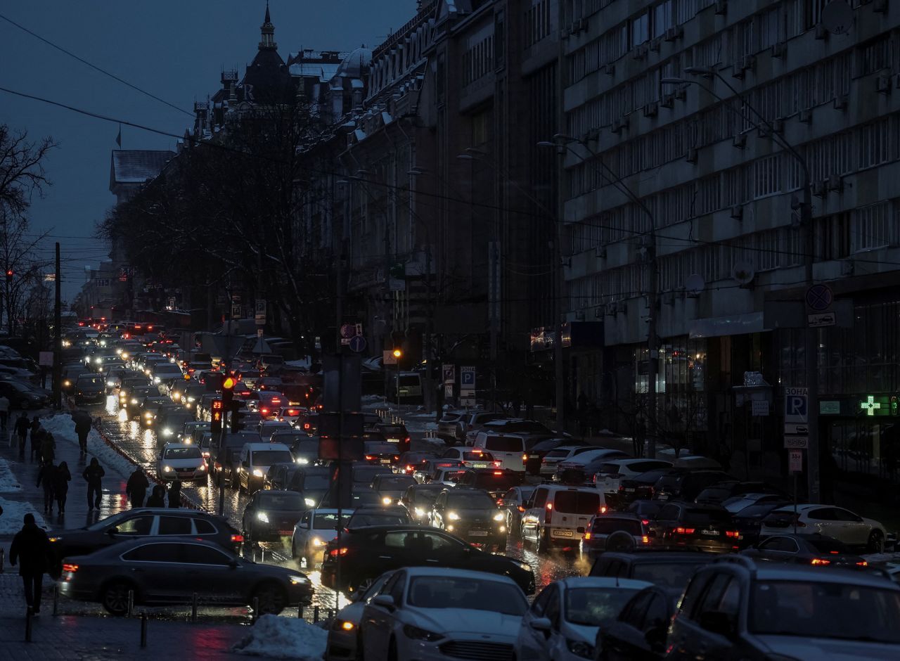 Cars lined up on a street?during a blackout after critical civil infrastructure was hit by Russian missile attacks in?Kyiv on December 16.
