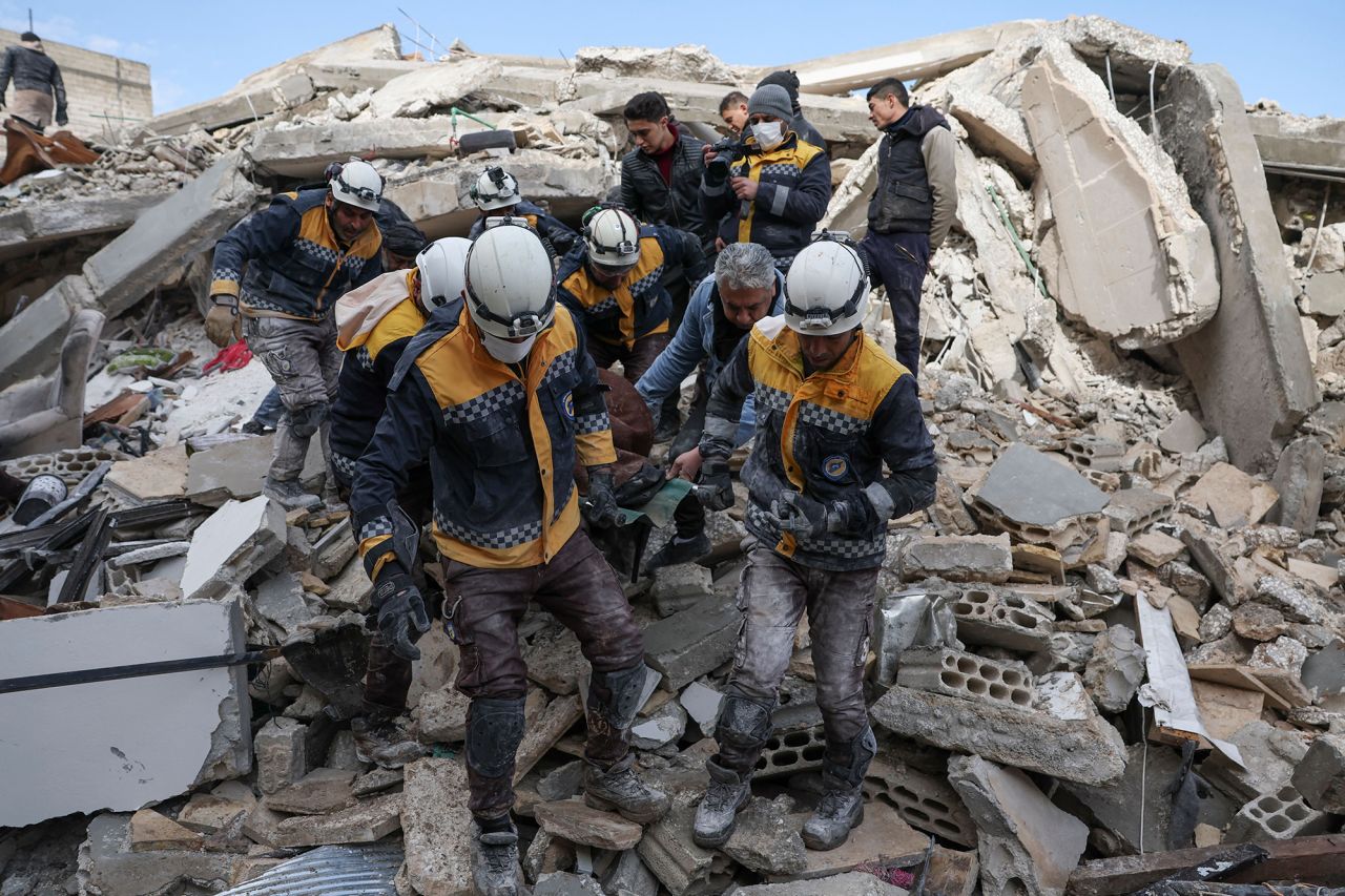 Members of the Syrian civil defense, known as the White Helmets, transport a casualty from the rubble of buildings in the village of Azmarin in Syria's rebel-held northwestern Idlib province on February 7. 