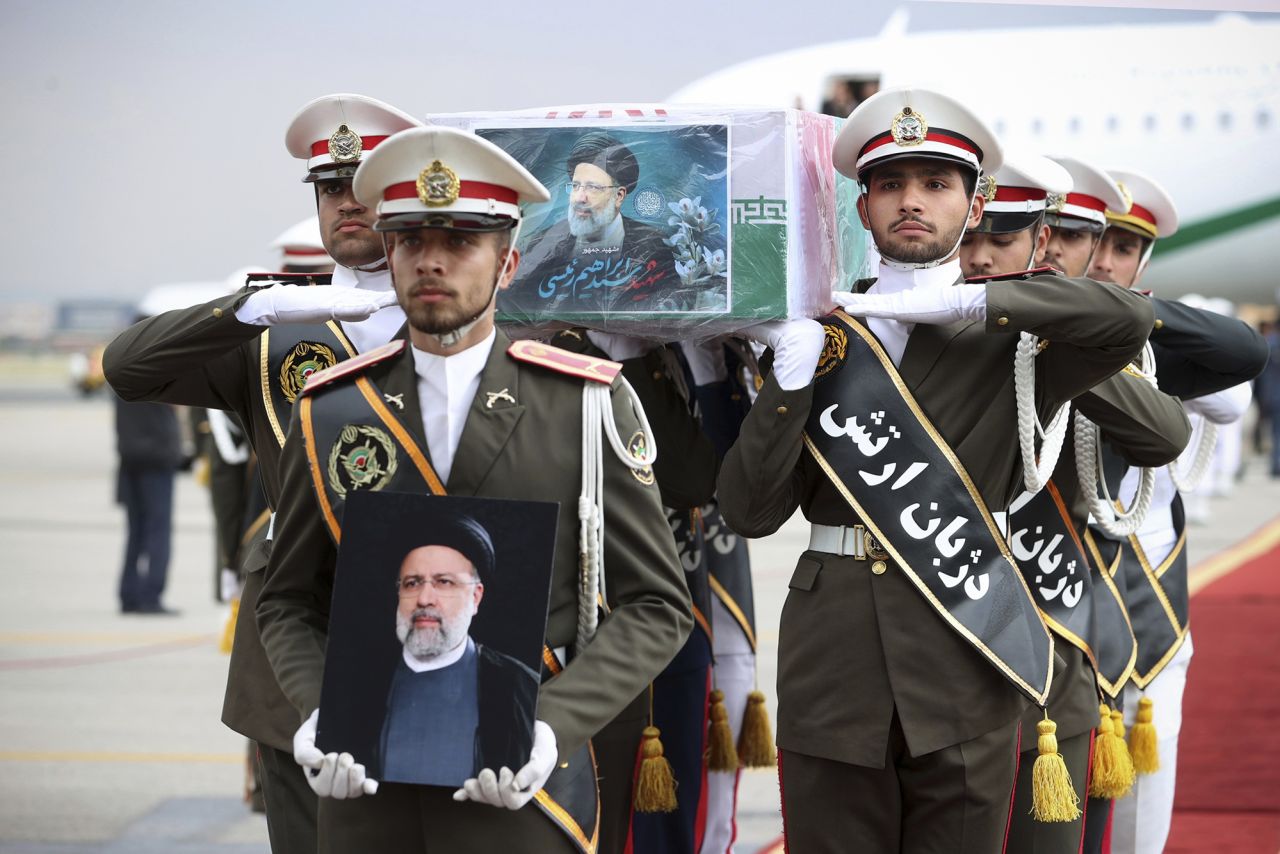 In this photo released by the Iranian Presidency Office, army members carry the flag-draped coffin of President Ebrahim Raisi during a funeral ceremony at Mehrabad airport in Tehran, Iran, on May 21.