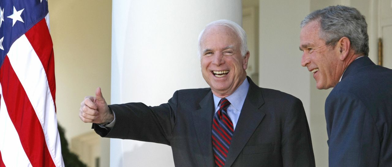 In this file photo, John McCain gives the thumbs up after speaking to the press with US President George W. Bush (R) in the Rose Garden of the White House on March 5, 2008 in Washington, DC. 