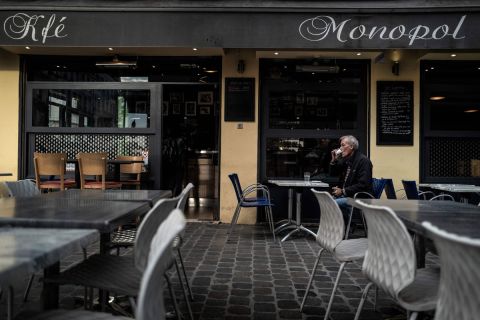 A customer drinks a coffee on a cafe terrace on October 9 in Lyon after the city was placed on maximum coronavirus alert. Four French cities including Lyon are placed on maximum coronavirus alert, joining Paris and other metropolises where bars have been shuttered in an increasingly urgent bid to brake a fast-accelerating outbreak of Covid-19.