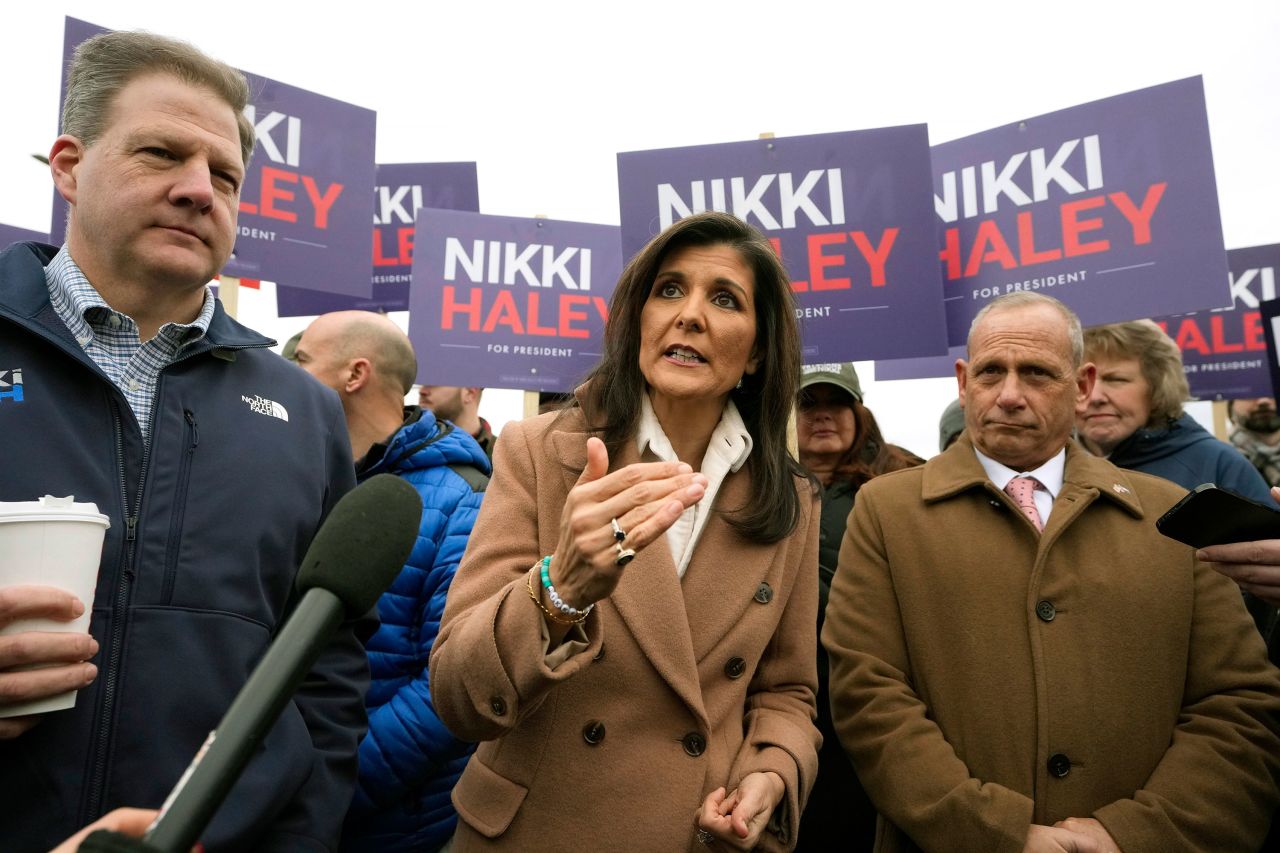 Nikki Haley addresses members of the media while standing with New Hampshire Gov. Chris Sununu, left, and retired US Army Brig. Gen. Donald Bolduc, right, in Hampton, New Hampshire.
