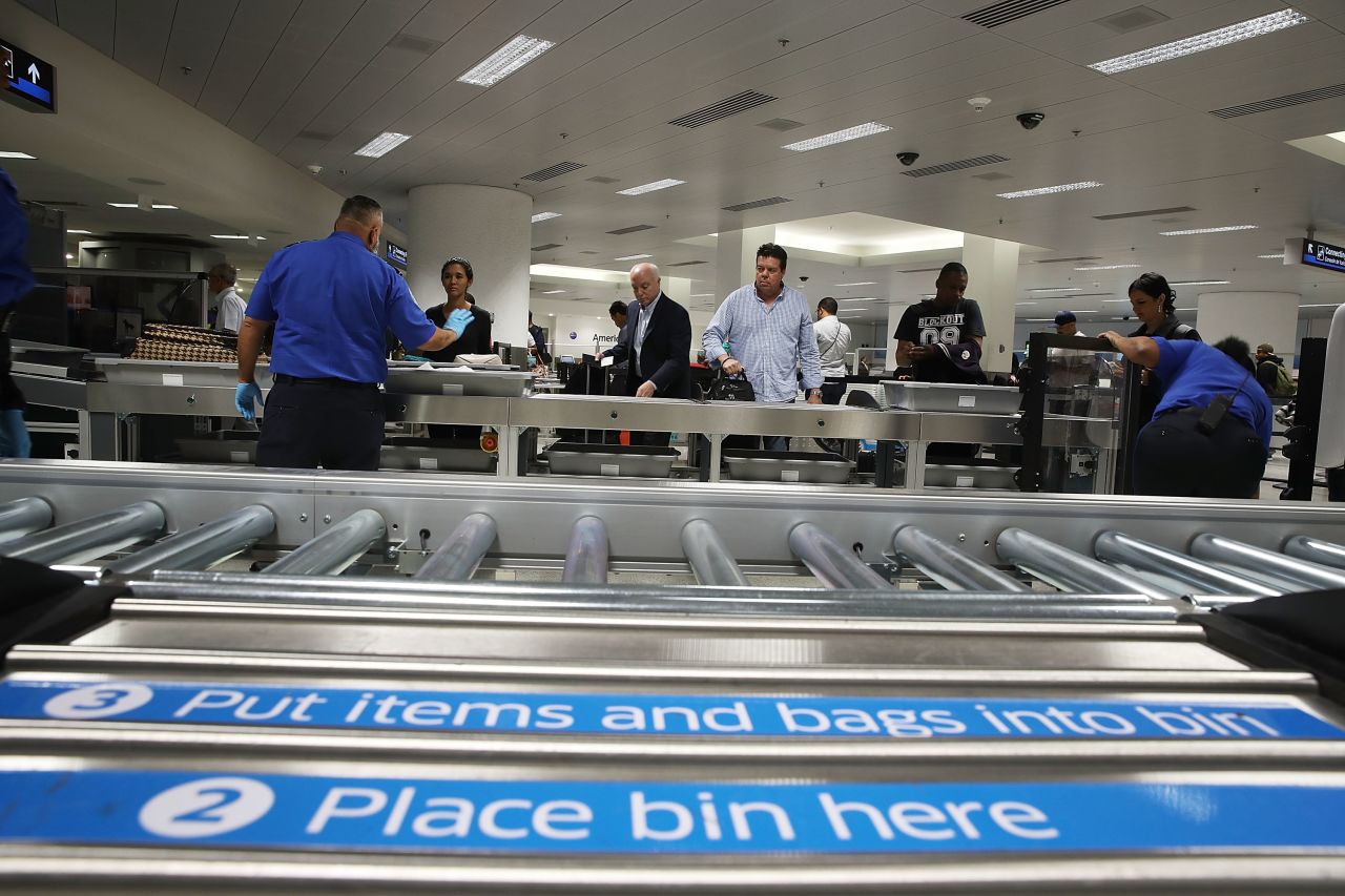 Travelers pass through Transportation Security Administration screening at Miami International Airport in October.