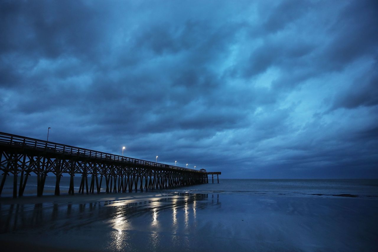 Storm clouds are seen over a pier in Myrtle Beach on Friday 