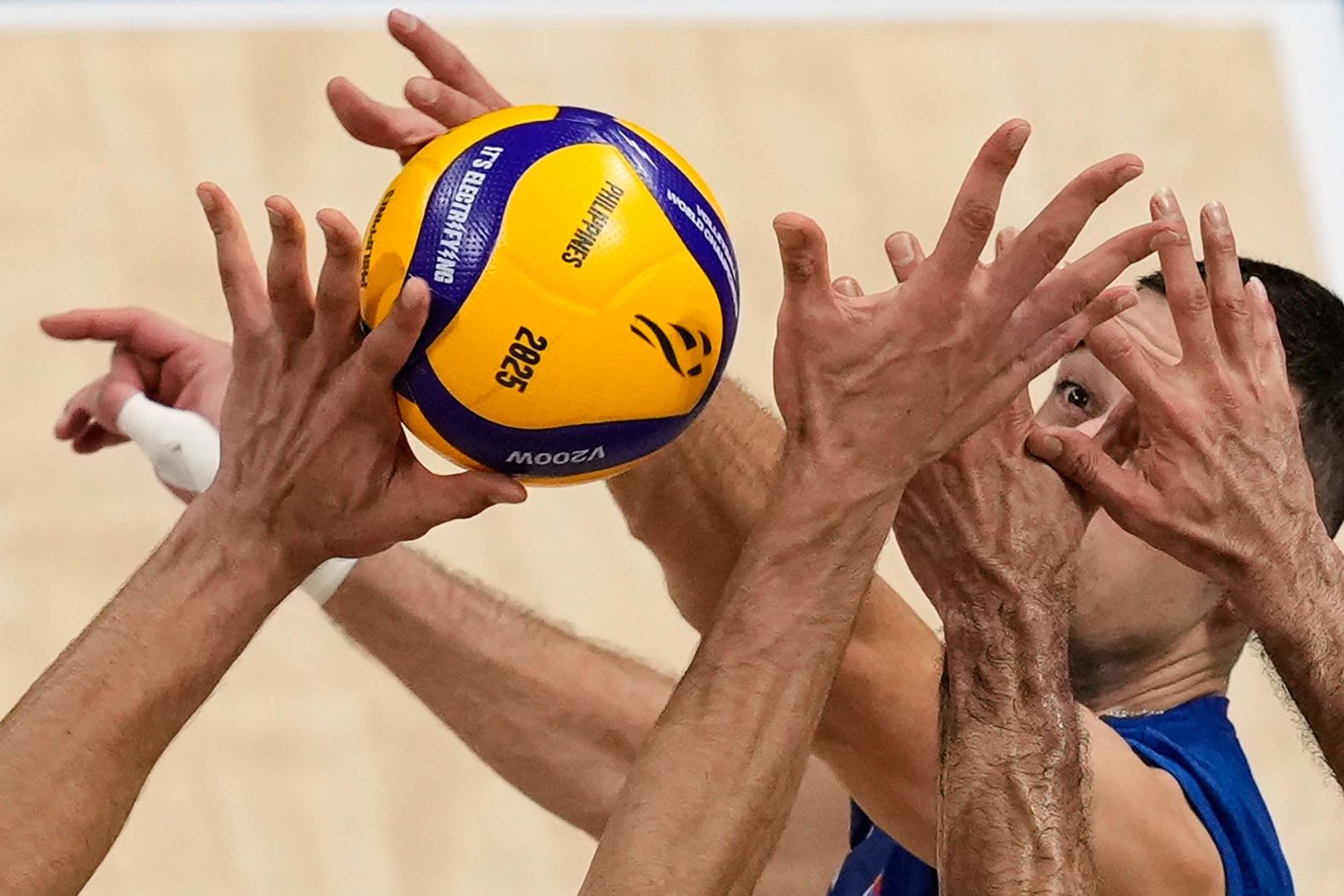 Serbia’s Pavle Perić faces the outstretched hands of Iranian players during a round-of-16 match at the Volleyball World Championship on Tuesday, September 23.