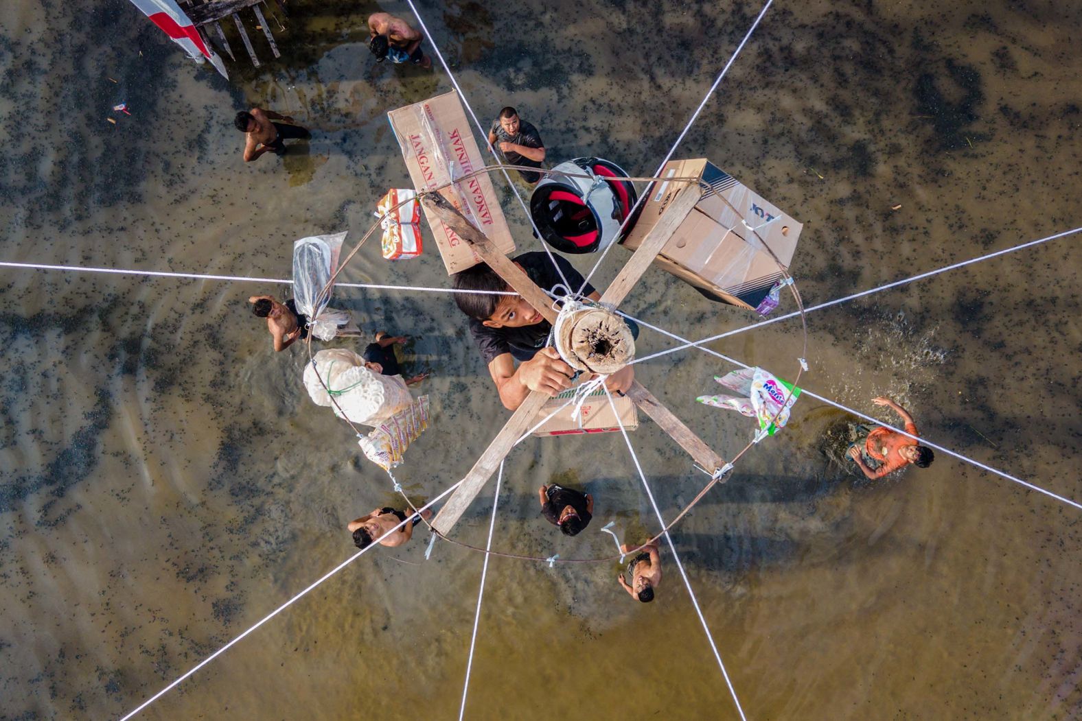 A participant climbs a greasy pole to reach prizes during a traditional game called Panjat Pinang during celebrations to mark Indonesia's 80th Independence Day on Sunday, August 17, on the outskirts of Banda Aceh, Indonesia.