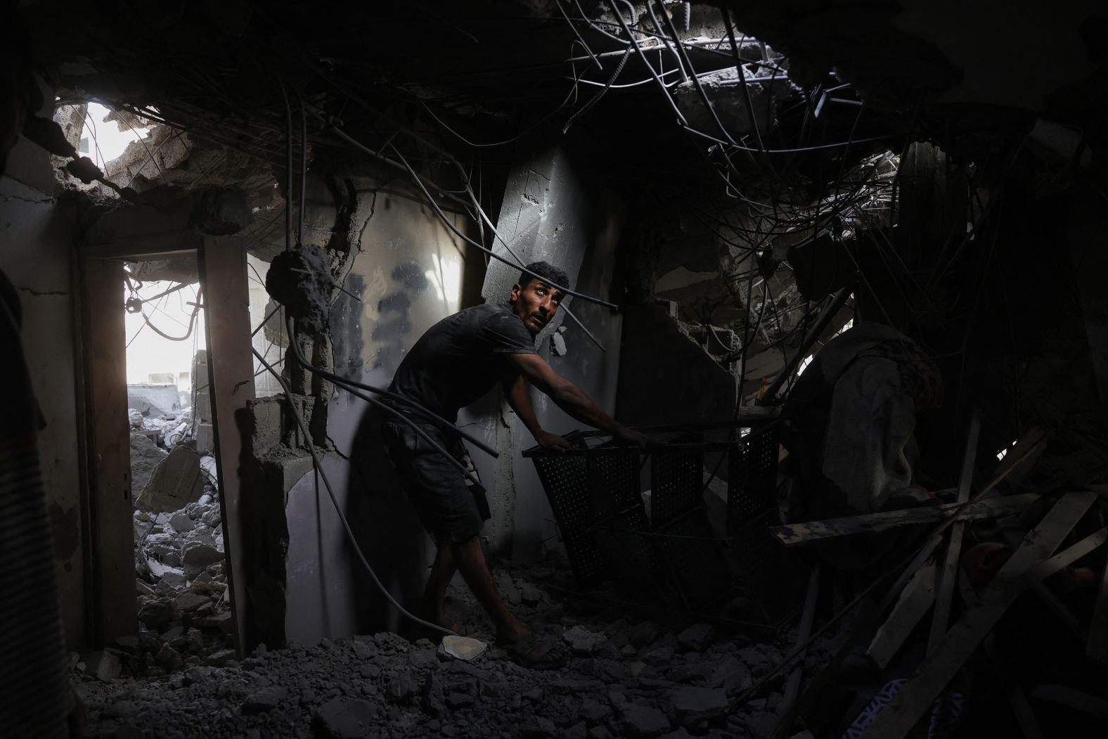 A Palestinian man searches the rubble of a house hit by Israeli strikes in northern Gaza on Sunday, May 18. <a href="https://www.cnn.com/2025/05/18/middleeast/israel-gaza-peace-talks-millitary-operation-intl">Israel launched an extensive ground operation in Gaza on Sunday</a> in addition to an intense air campaign that health officials in the territory say killed over 100 people overnight.