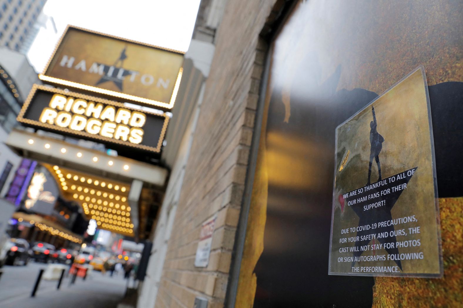 Signage regarding Covid-19 precautions is seen on a doorway at the Richard Rodgers Theatre in March 2020.