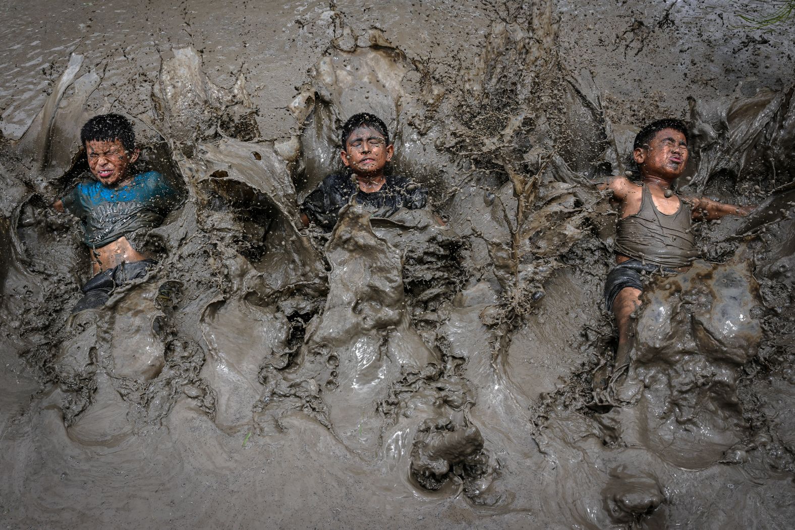 Children splash in mud as they celebrate the start of the annual rice planting season in the Nepalese village of Jitpur Phedi on Sunday, June 29.