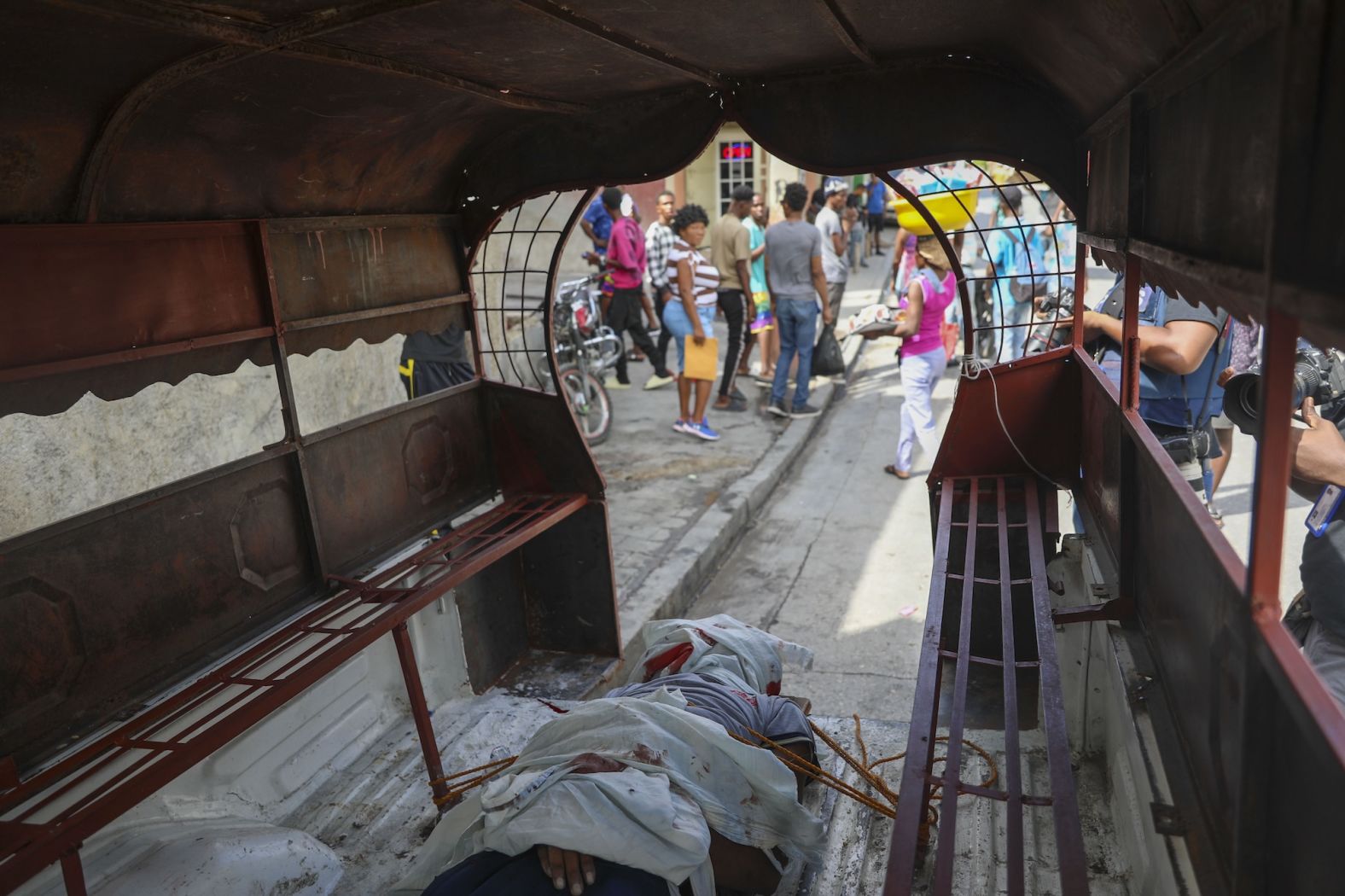 The body of a man who was shot dead by a stray bullet is secured to the floor of a truck in the Solino neighborhood of Port-au-Prince, Haiti, on Tuesday, November 12. Haiti has been ridden with <a href="index.php?page=&url=https%3A%2F%2Fwww.cnn.com%2F2024%2F11%2F11%2Famericas%2Fhaiti-spirit-airlines-jetblue-intl-latam">widespread gang activity and political chaos</a> for nearly a year.