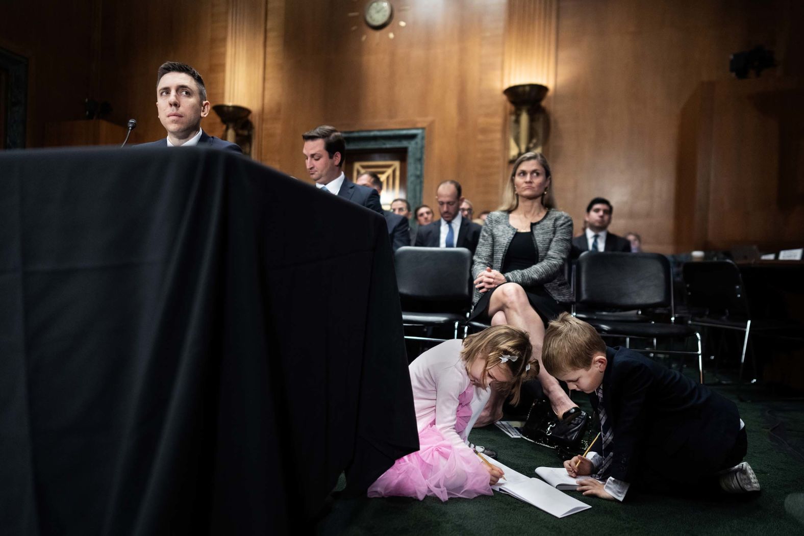 The children of Travis Hill, President Donald Trump’s nominee to be chairman of the Federal Deposit Insurance Corporation, draw on notepads during his confirmation hearing in Washington, DC, on Thursday, October 30.