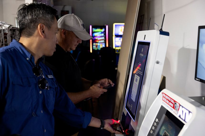 Members of the Secret Service test a cryptocurrency ATM at a convenience store in Atlanta in August.