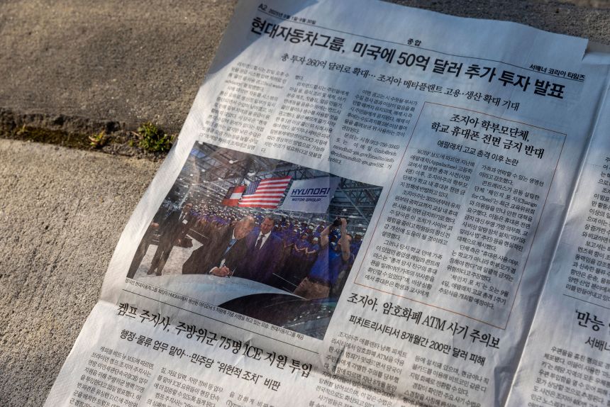 A photograph of Georgia Gov. Brian Kemp and Hyundai Motor Group Executive Chair Euisun Chung is displayed in an issue of the Savannah Korean Times newspaper on Friday.