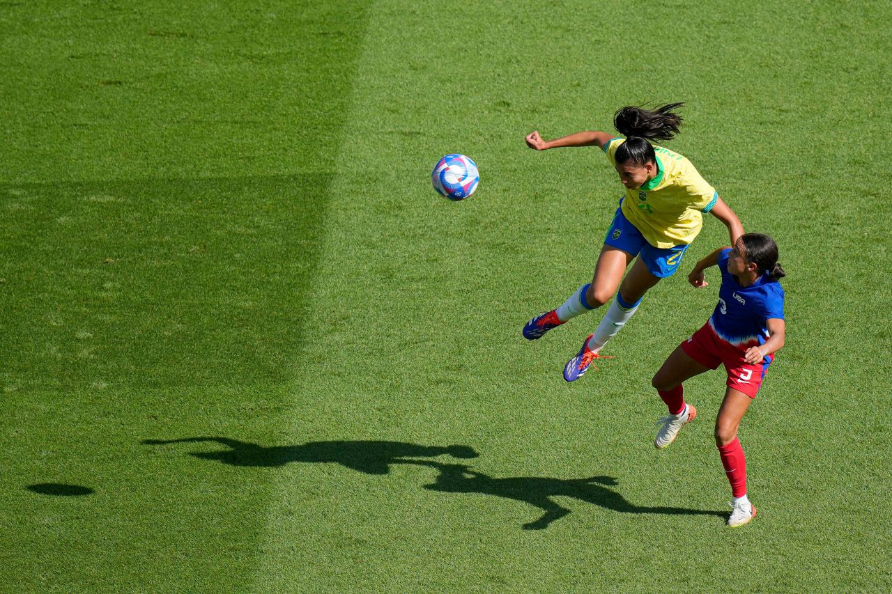 Brazil's Lauren goes for a header with Mallory Swanson of the US. 