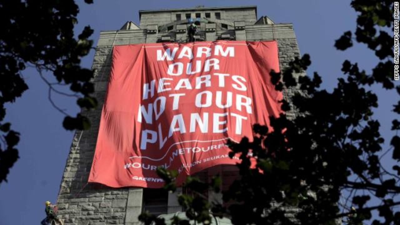 Greenpeace activists hang a banner on the Kallio Church tower in Helsinki.