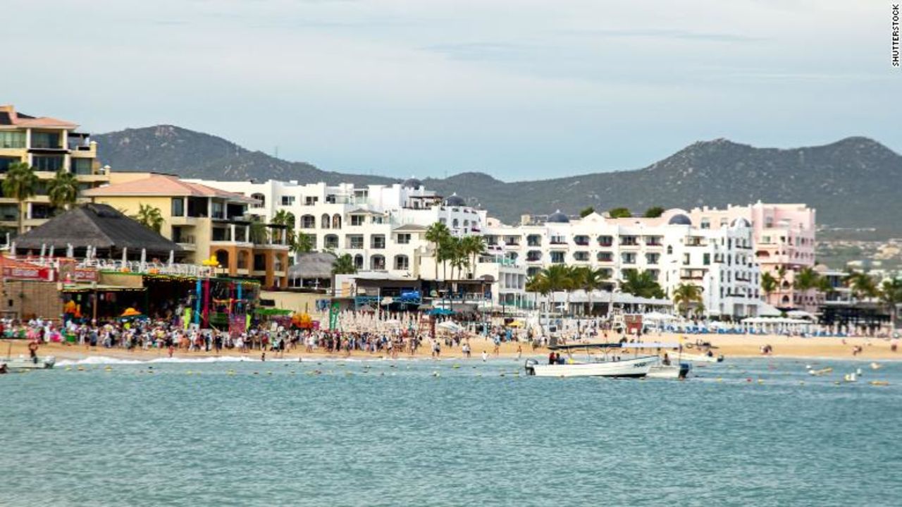 People walk on the beach in Cabo San Lucas, Mexico on March 23.